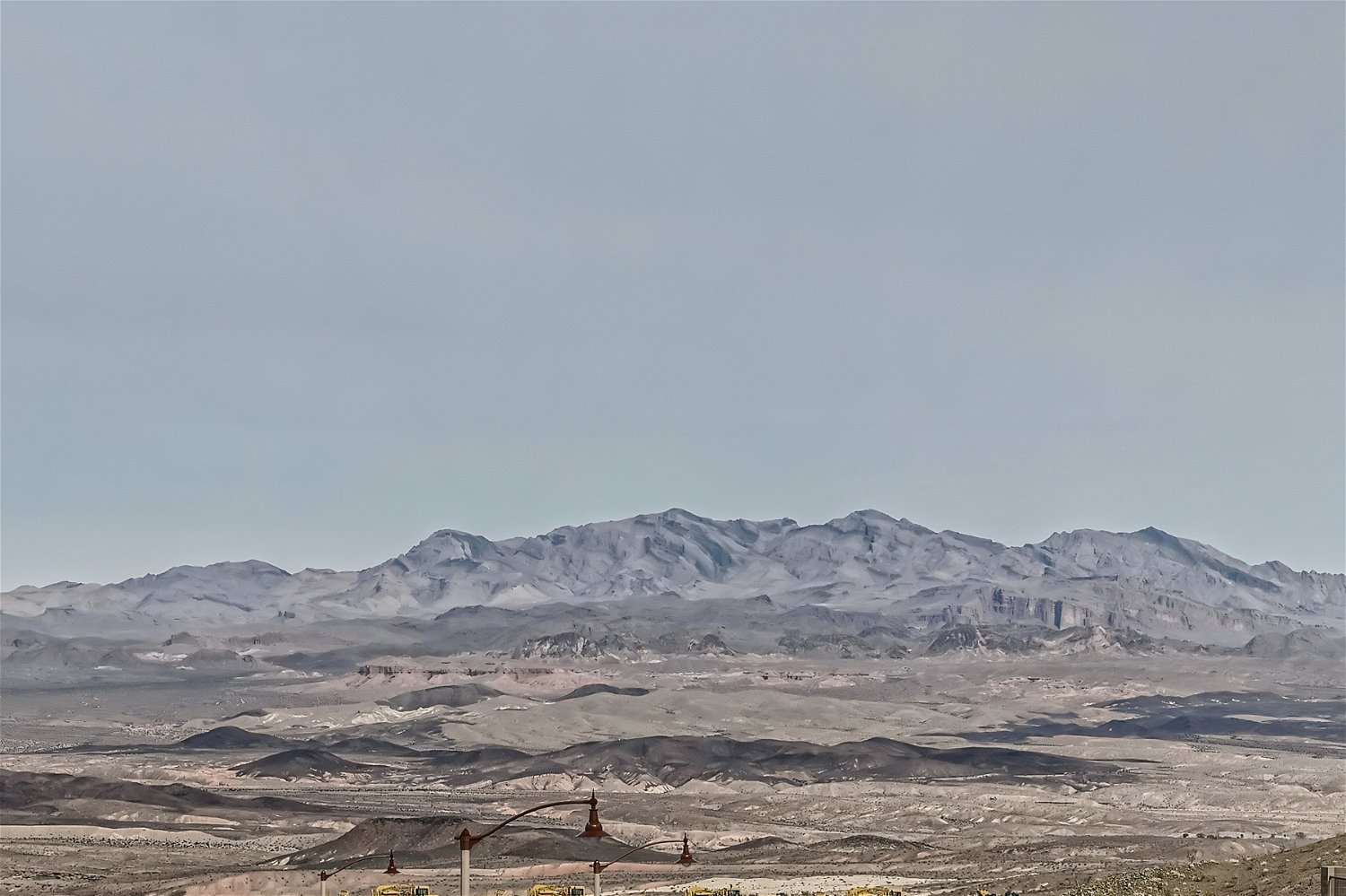 A snowy landscape with mountains in the background.