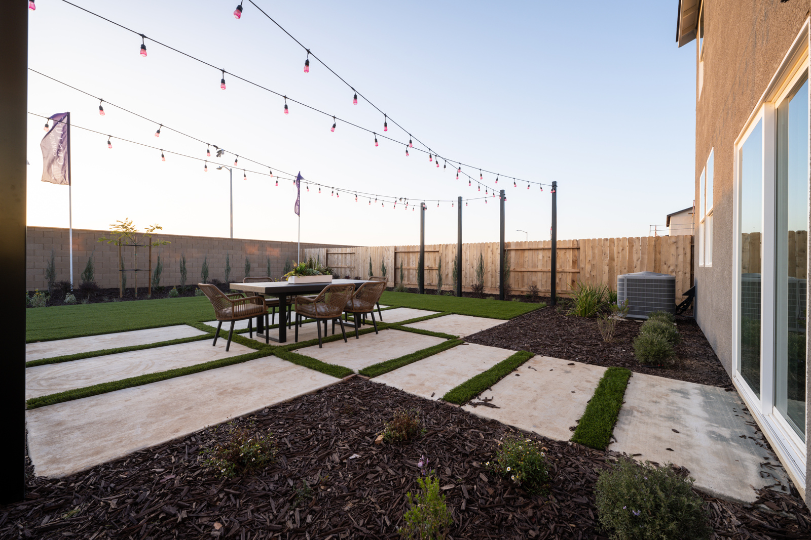 A patio with a table and chairs.