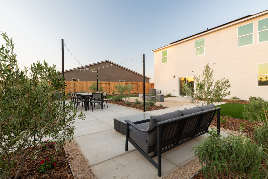 A patio with a couch and chairs.