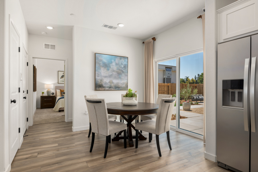 A dining room with a large glass door.