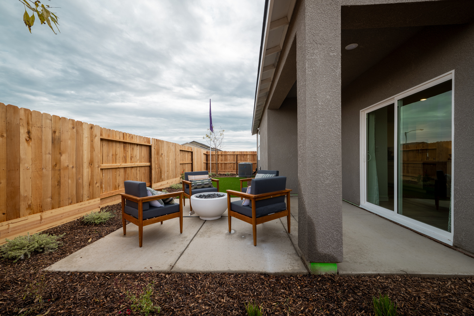 A patio with a table and chairs.