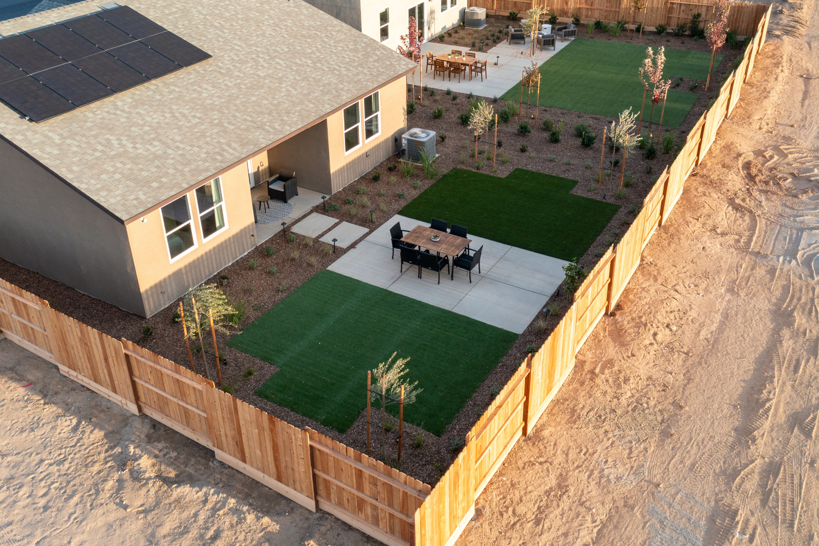 A backyard with a pool and a house.