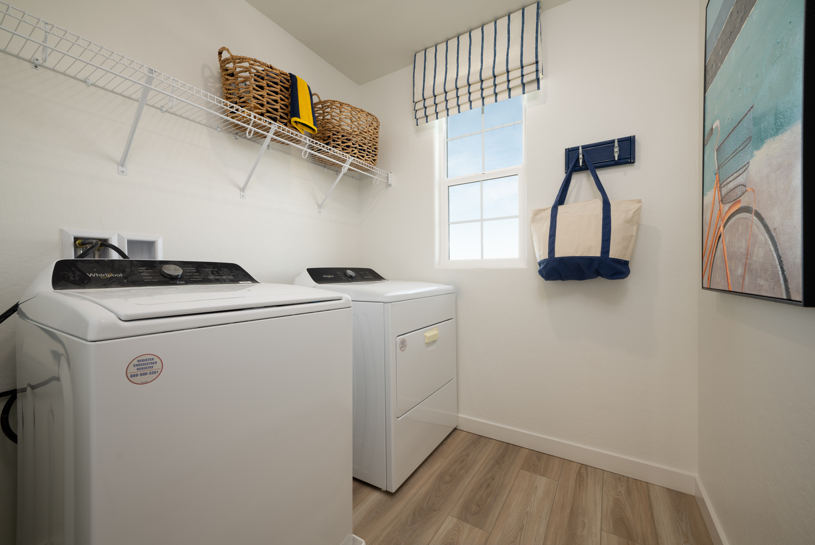 A laundry room with a laundry basket on the wall.