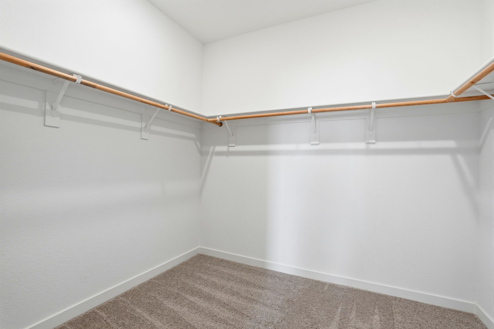 A white wall with a metal railing.