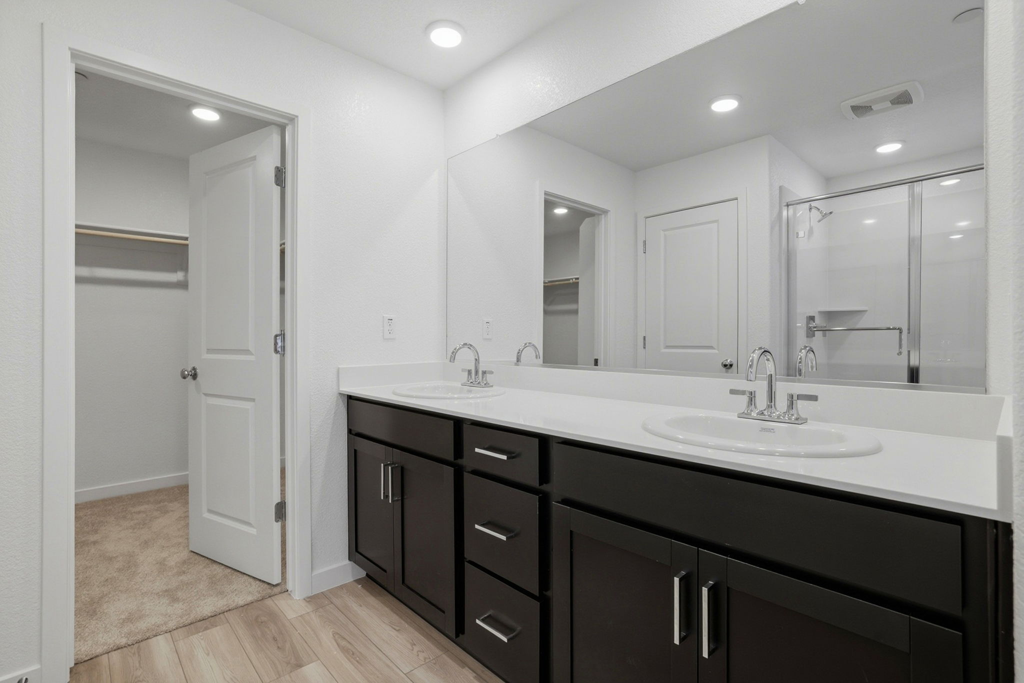 A bathroom with a large mirror.