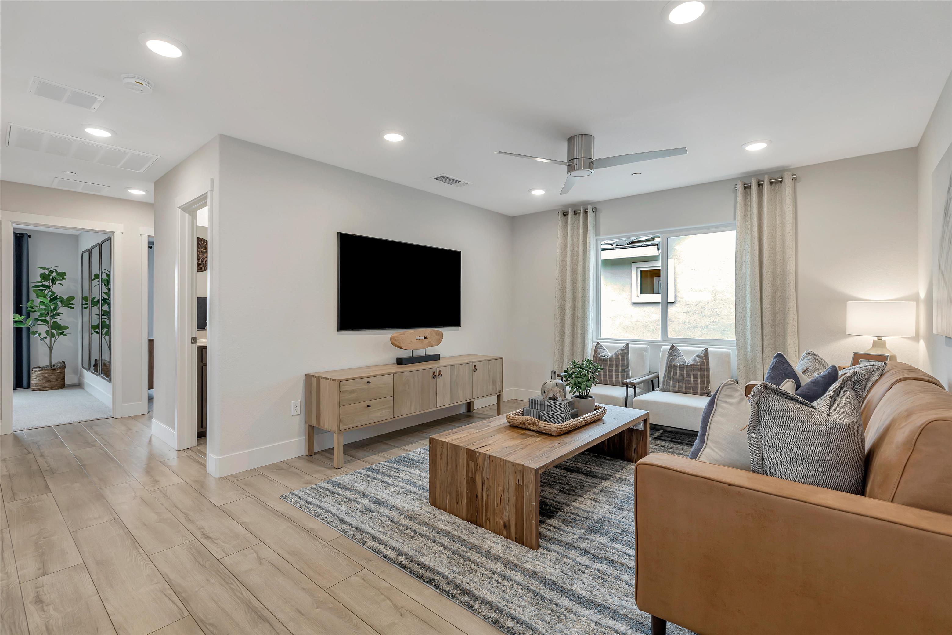 A living room with a tv and couches.