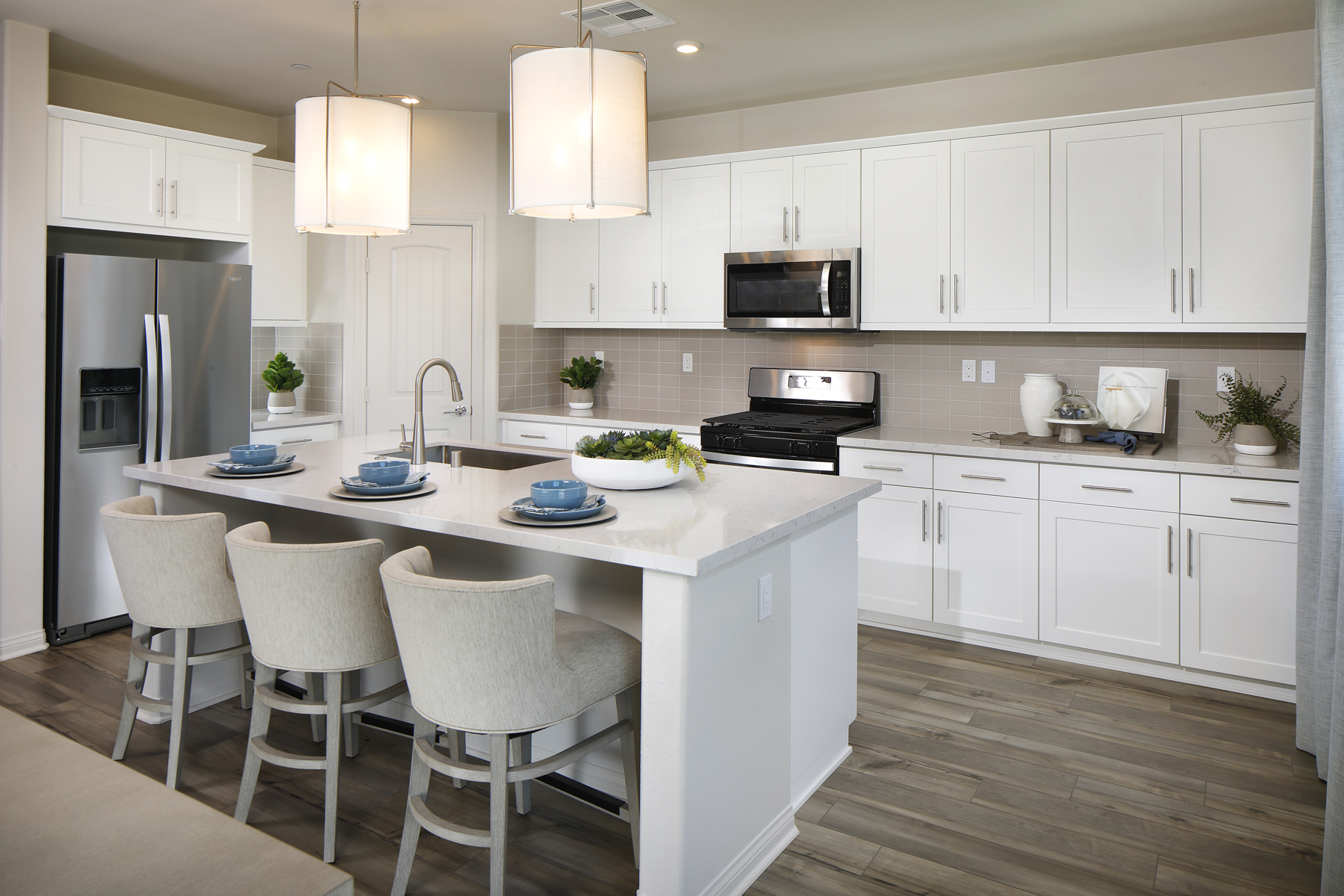 A kitchen with white cabinets.
