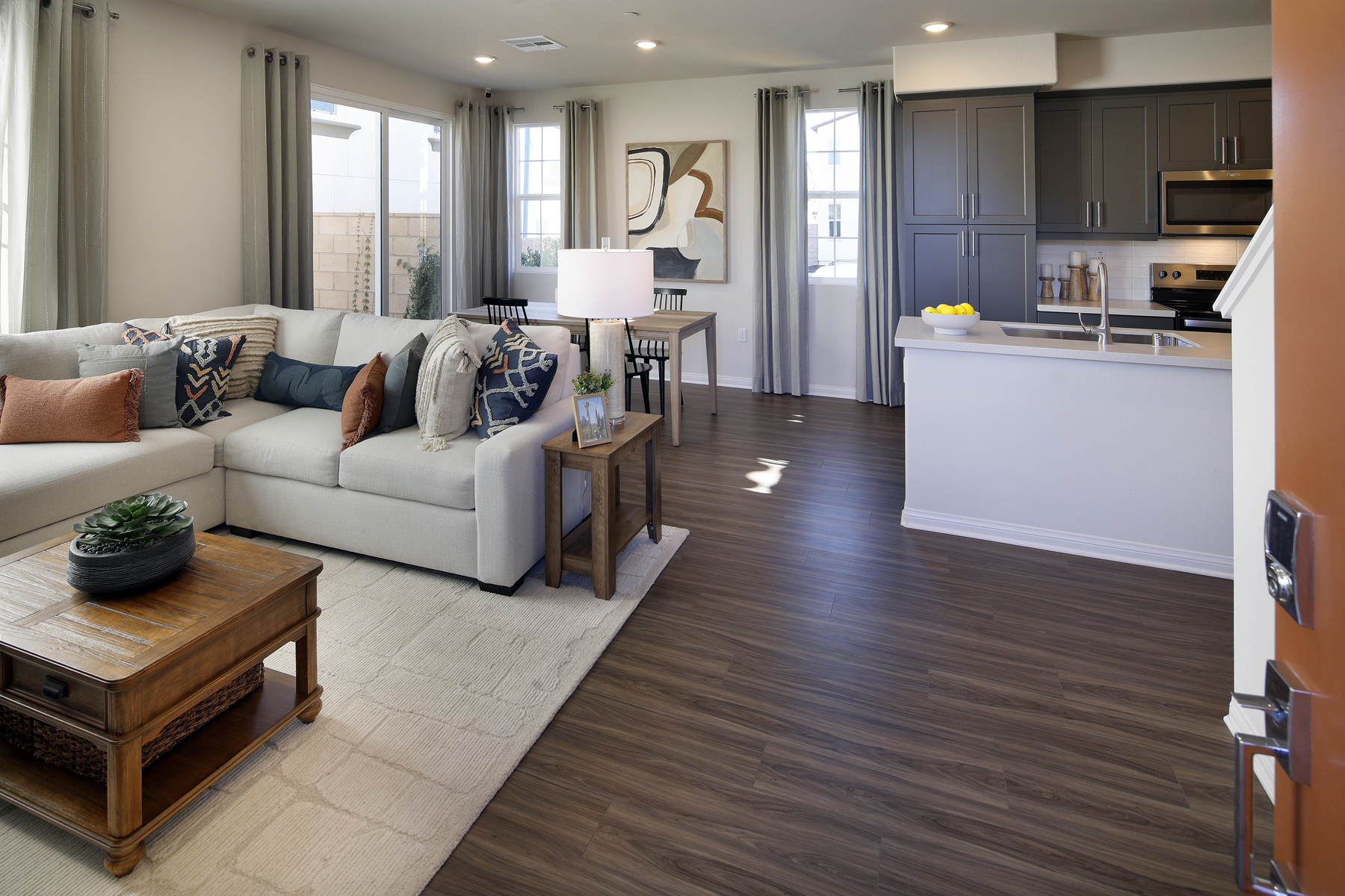 A living room with a large white couch and a table.