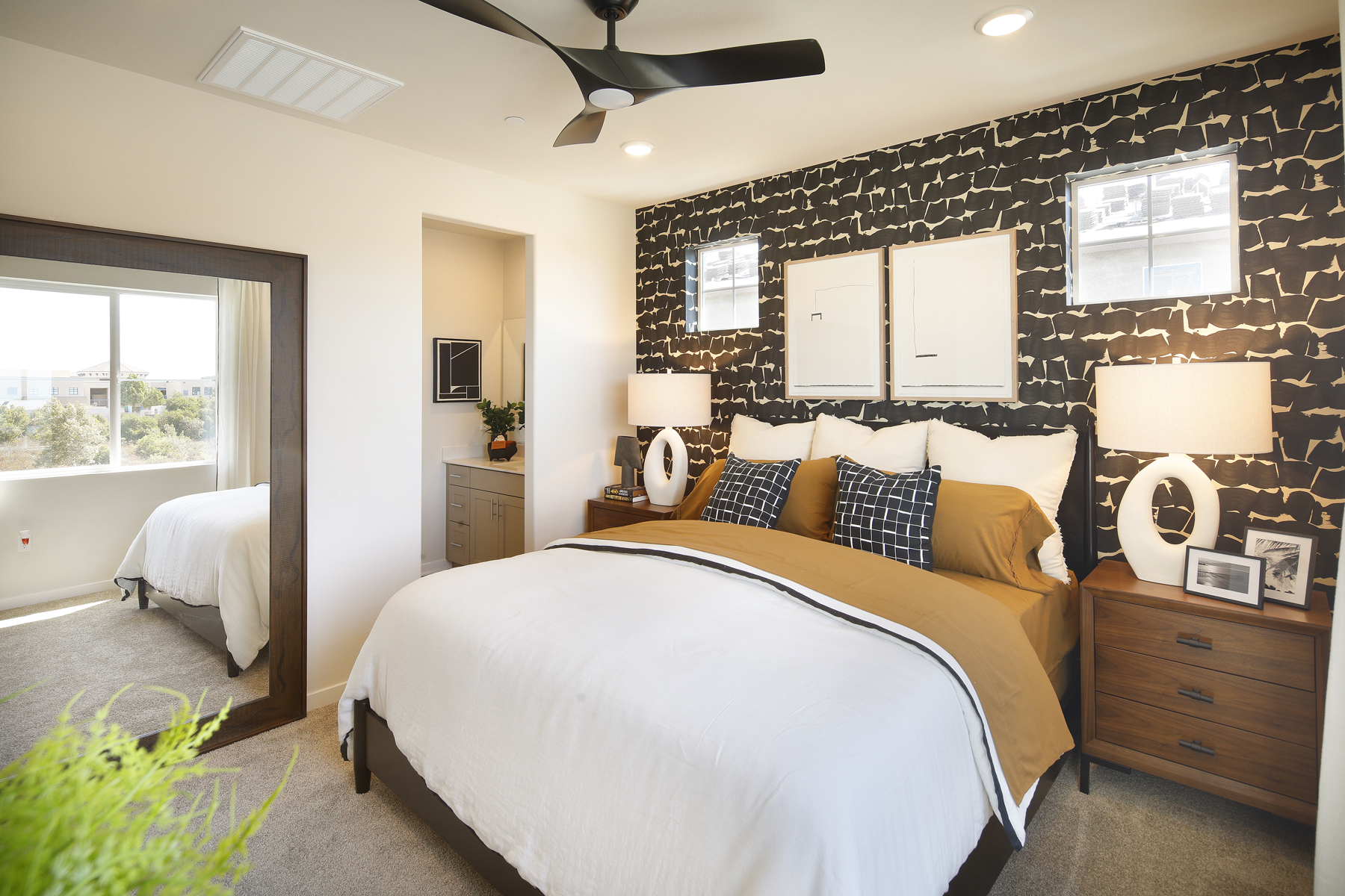 A bedroom with a bed and a fan.