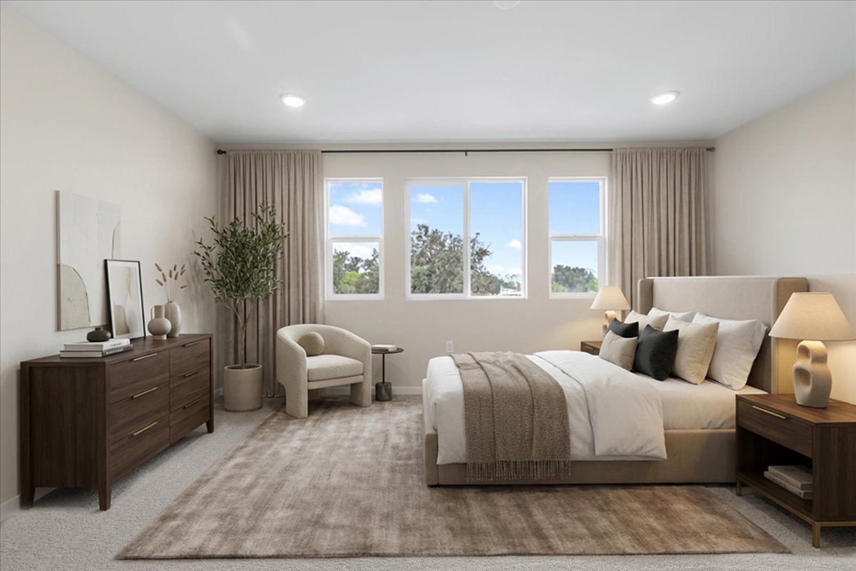 A bedroom with a bed and a chair.