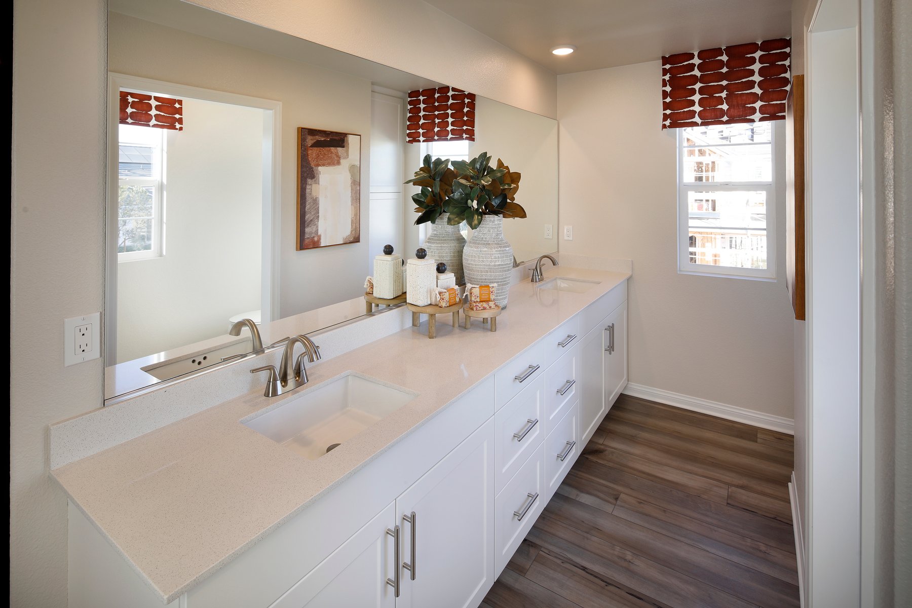 A bathroom with a large mirror.
