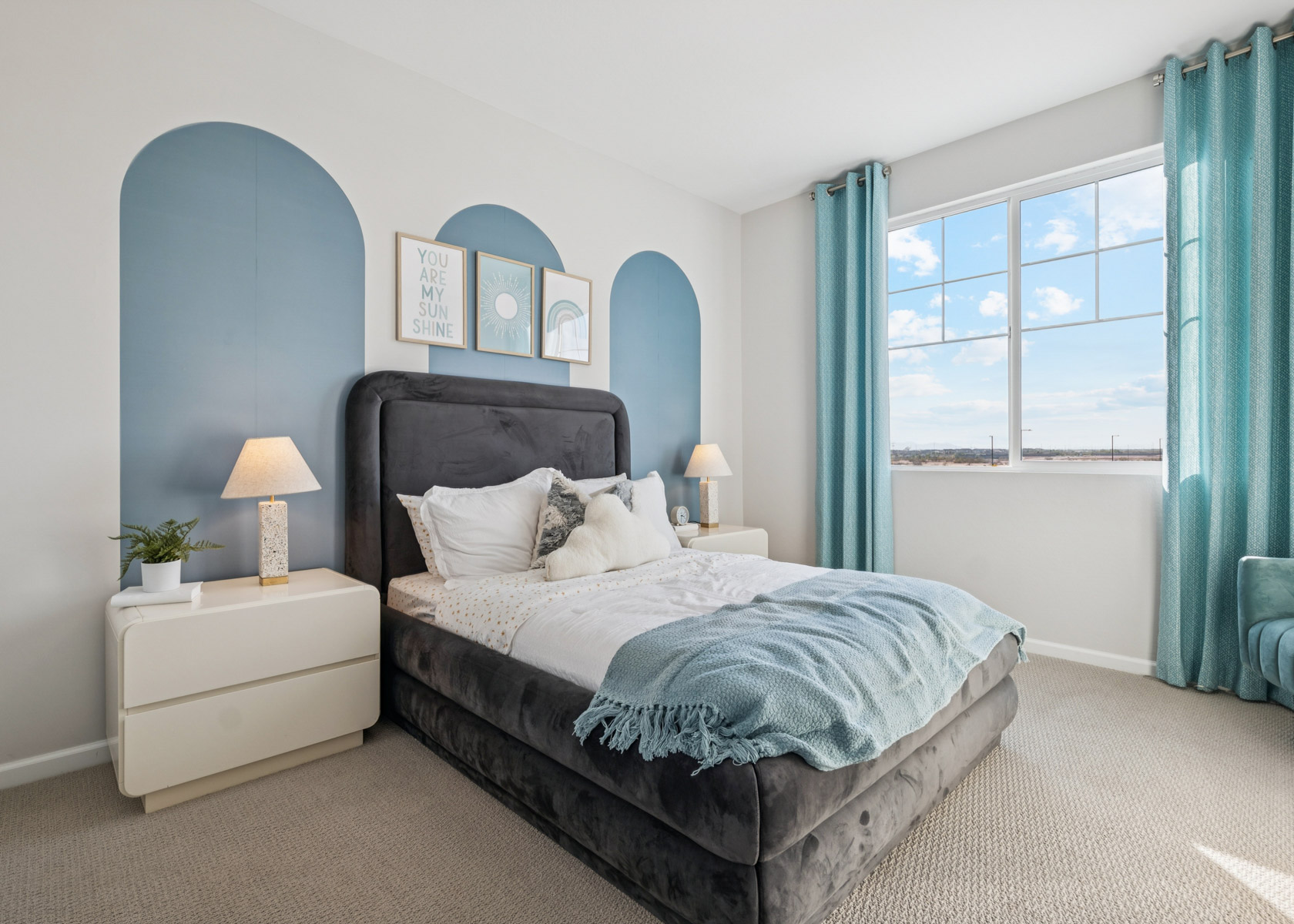 A bedroom with a bed and a window.