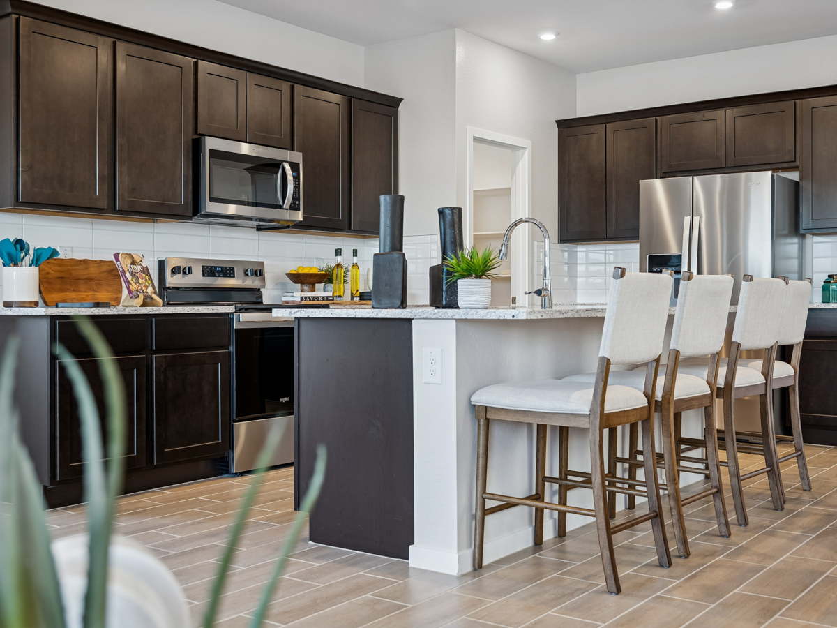 A kitchen with black cabinets.