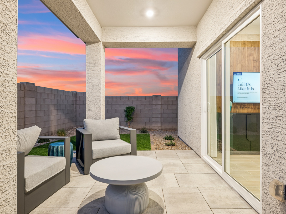 A room with a large glass door and a white chair and a white table with a white table.