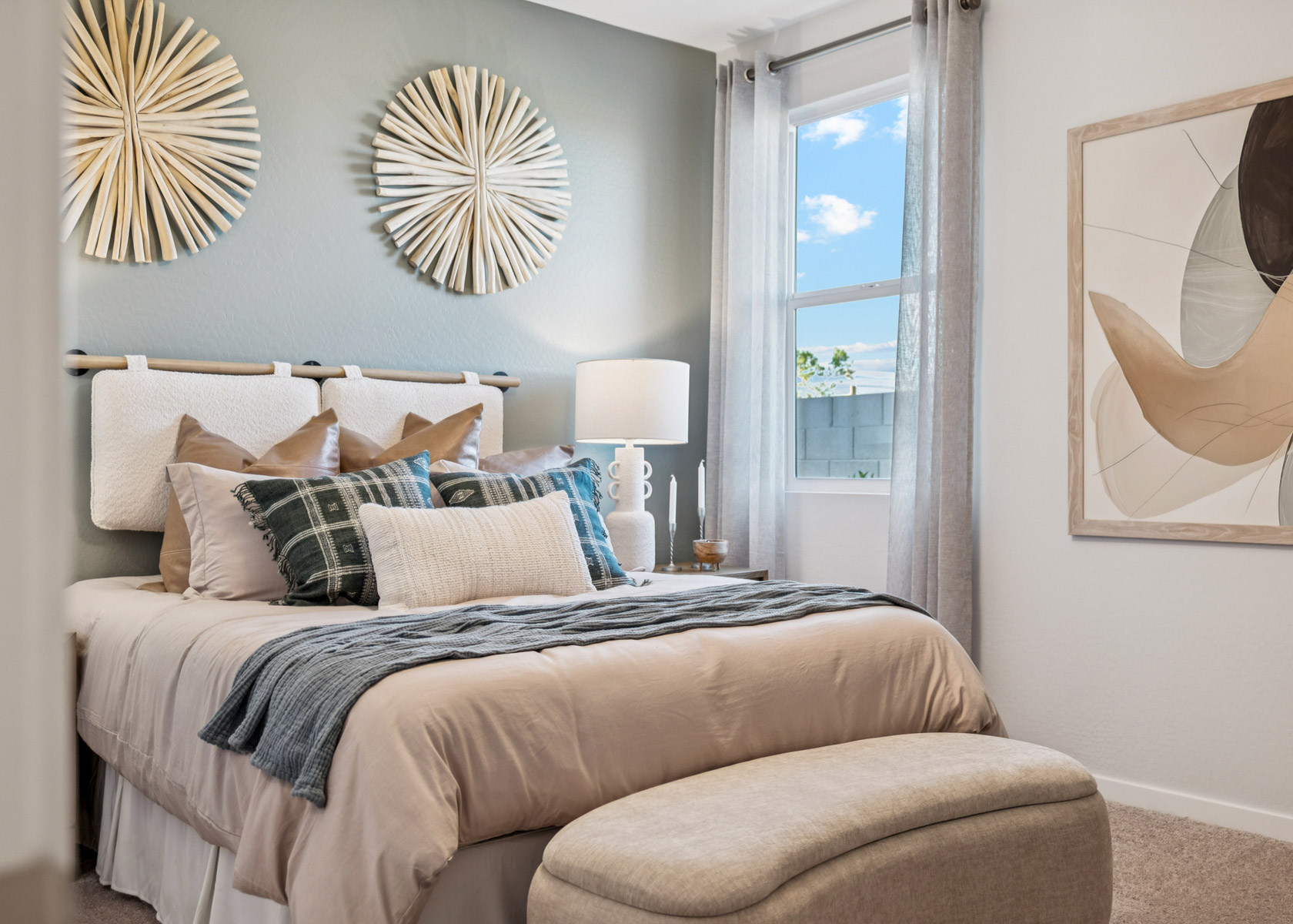 A bed with a large window.