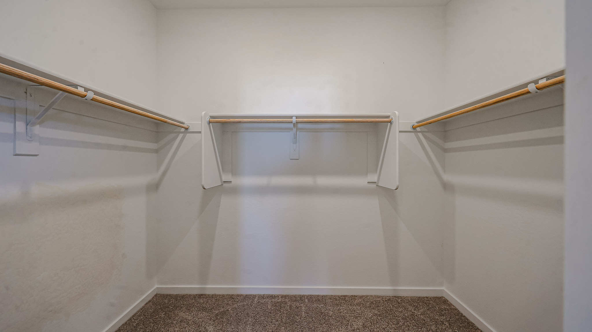 A white room with a metal bar.