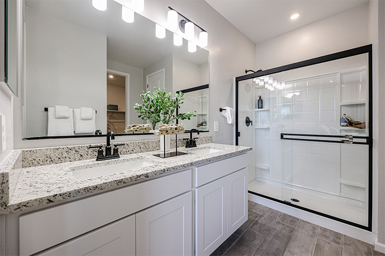 A bathroom with a large mirror.