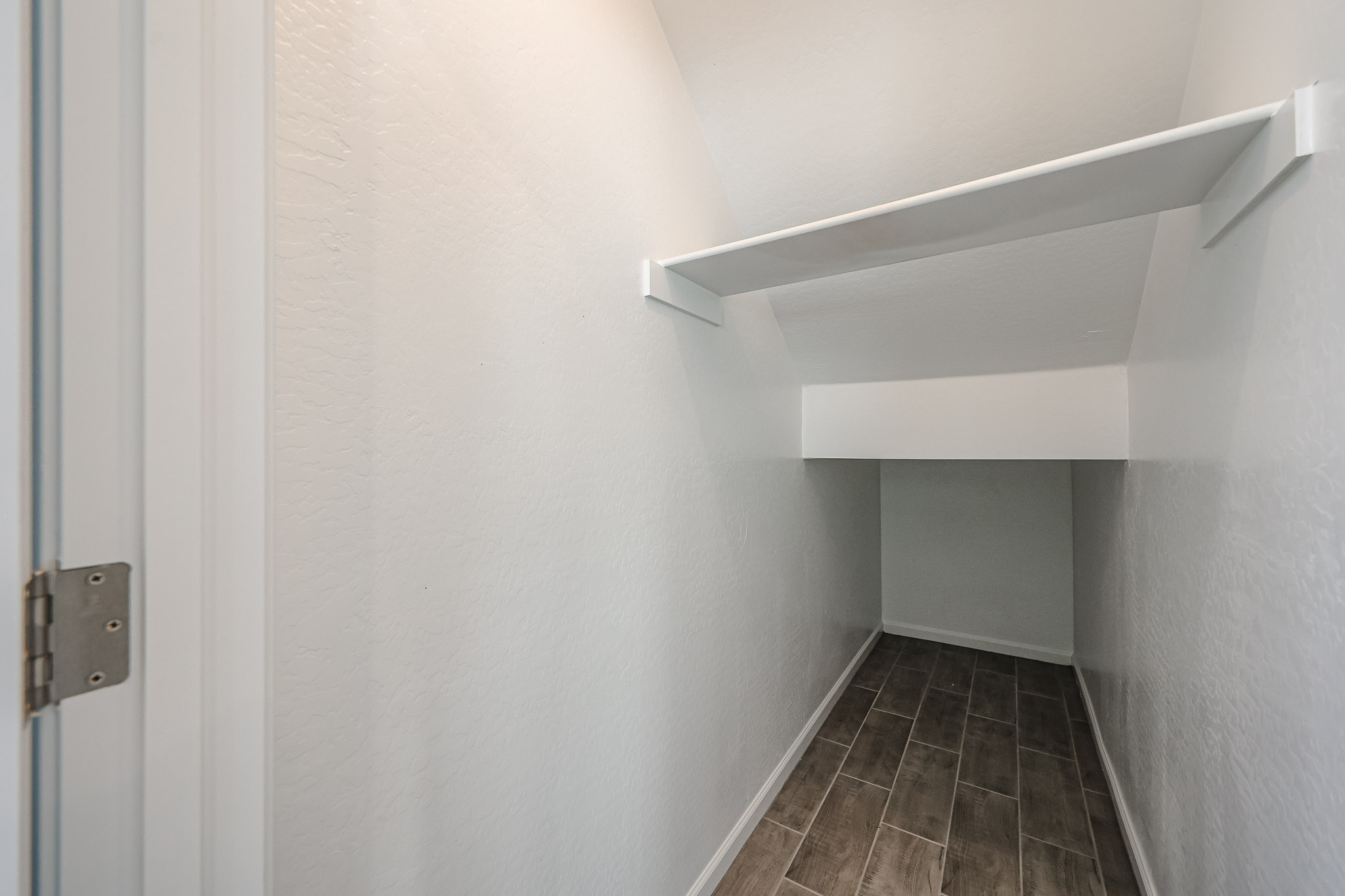 A hallway with white walls.