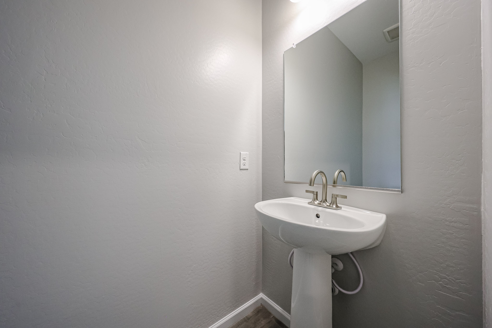 A bathroom with a mirror and sink.