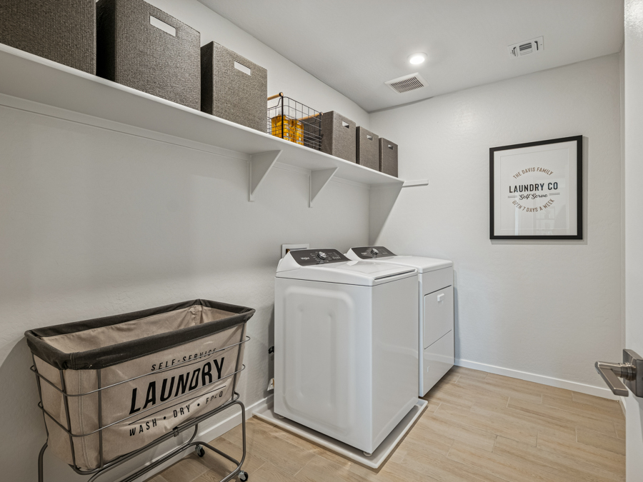 A room with a washer and dryer.