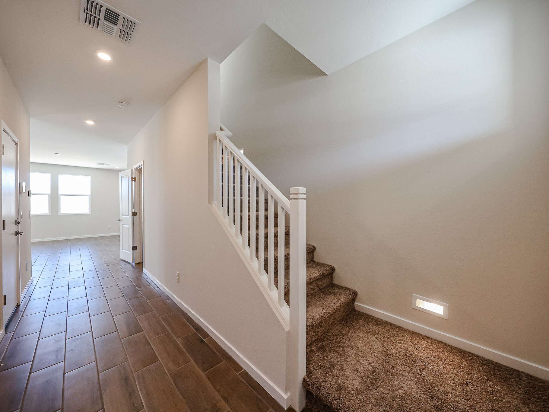 A hallway with white railings.
