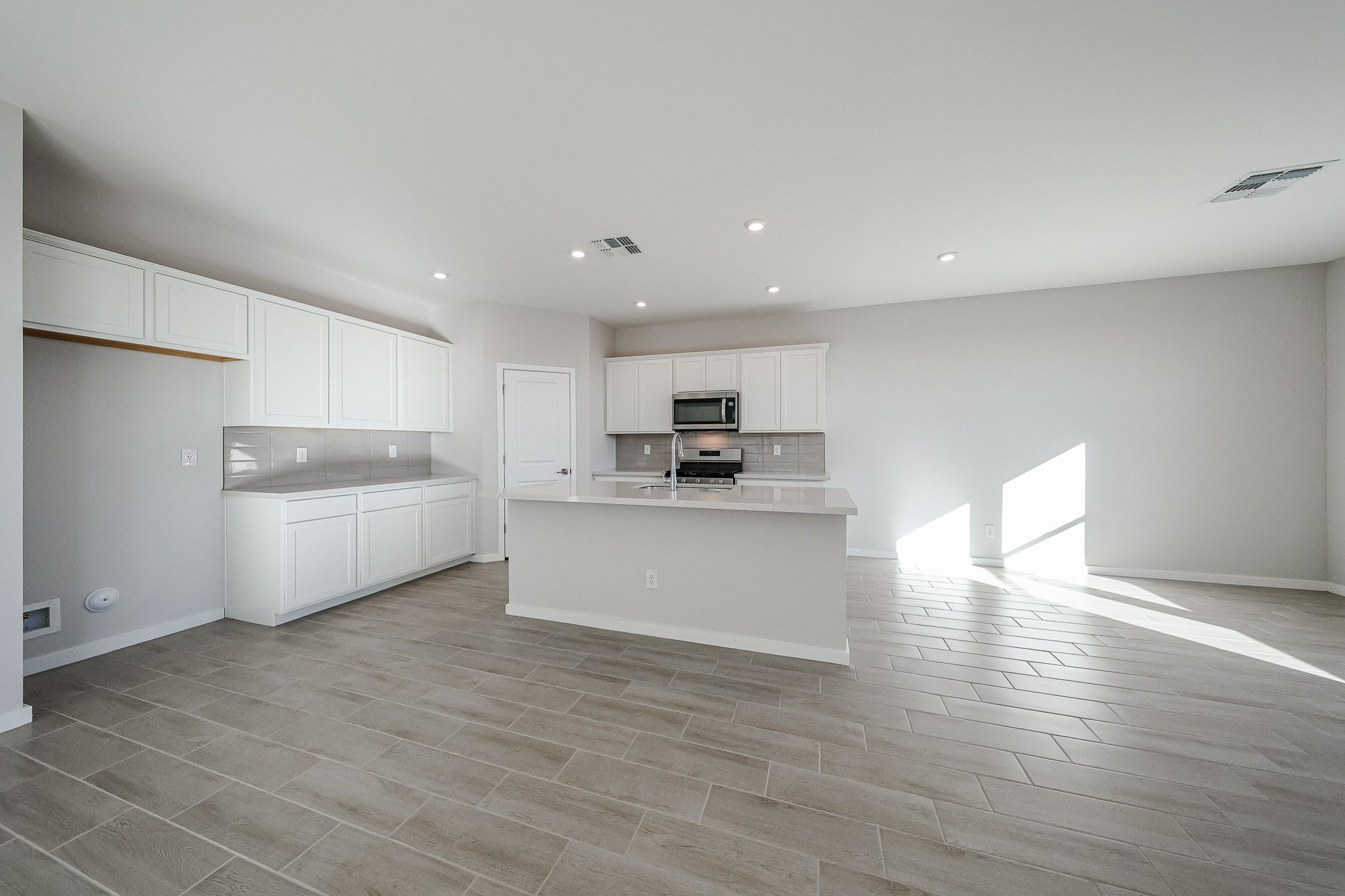 A kitchen with white cabinets.