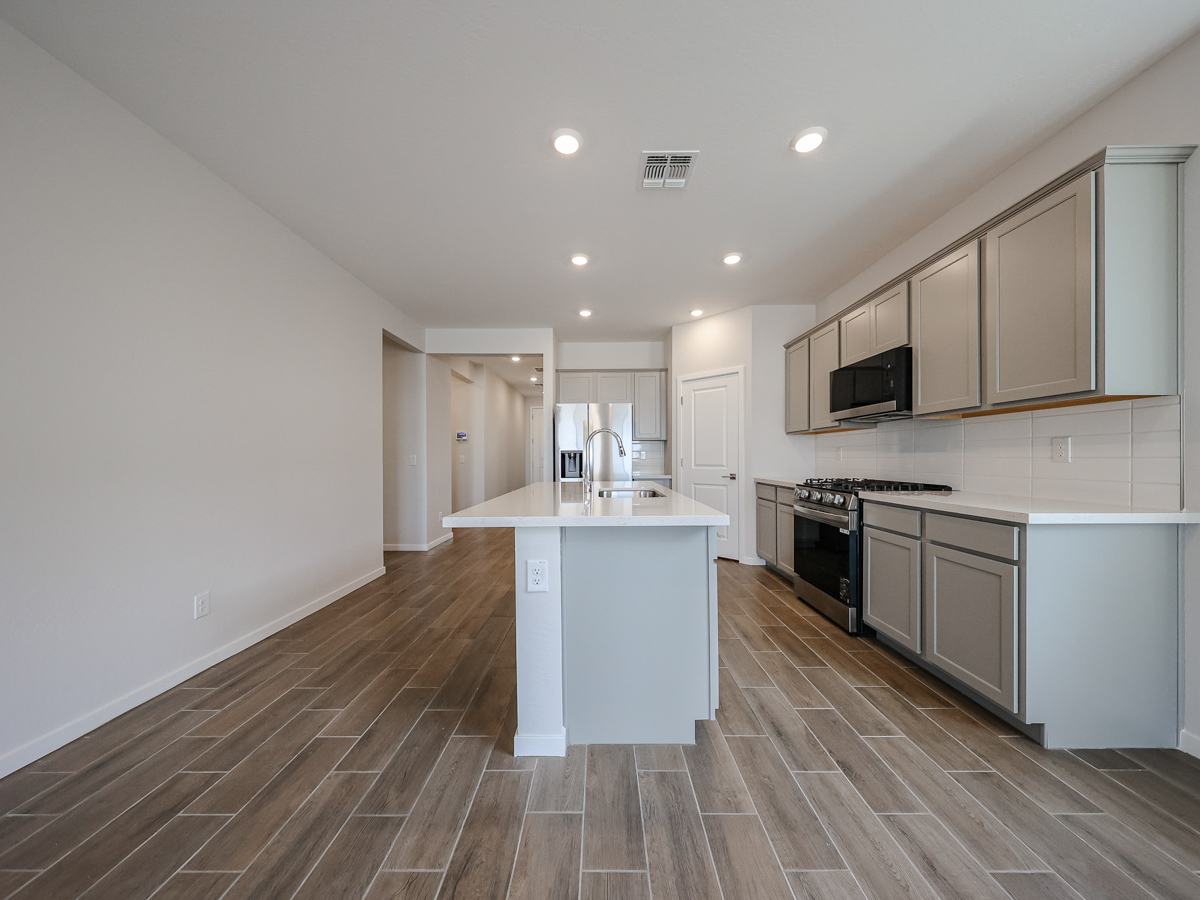 A kitchen with white cabinets.