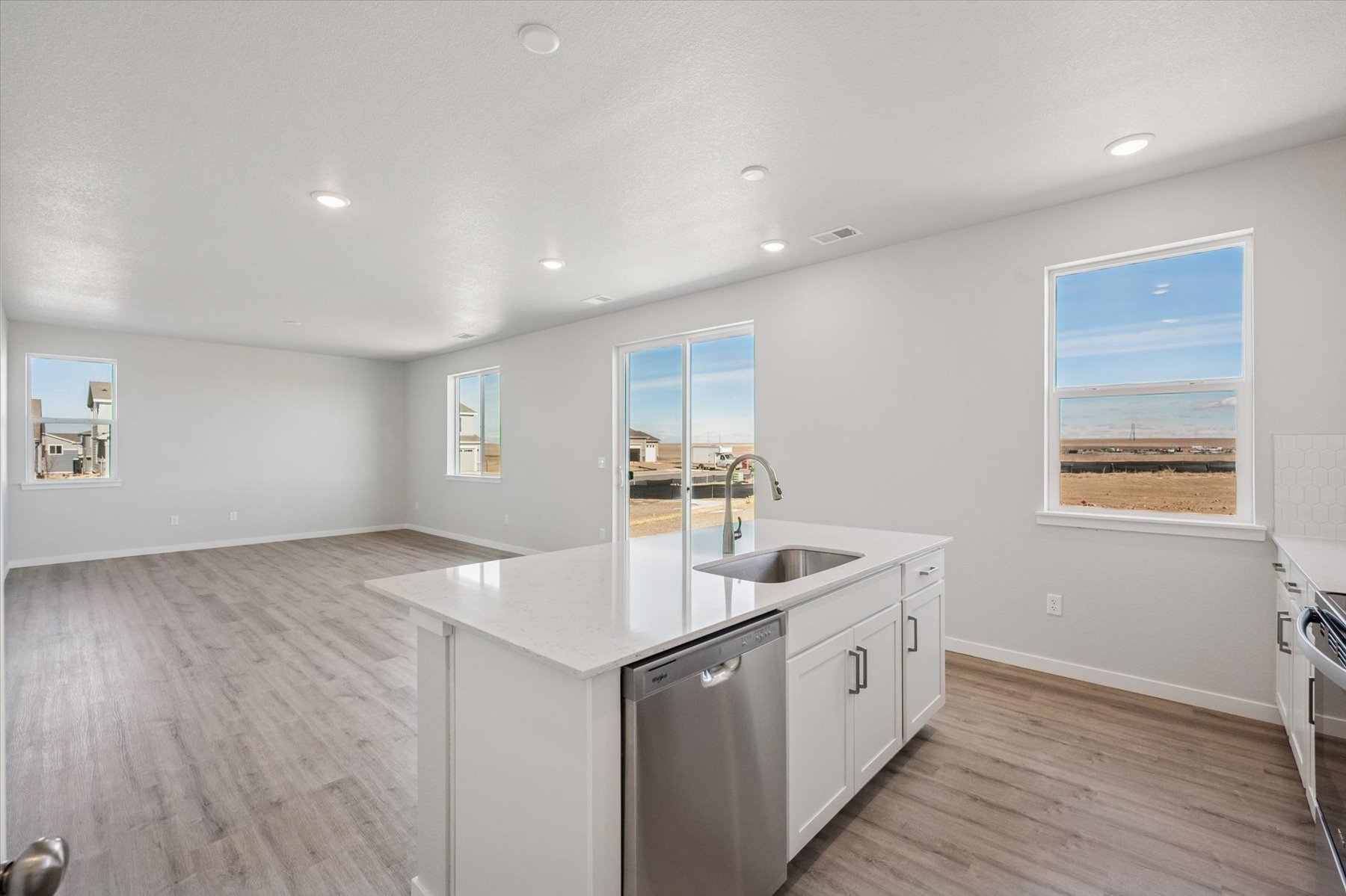 A kitchen with white cabinets.