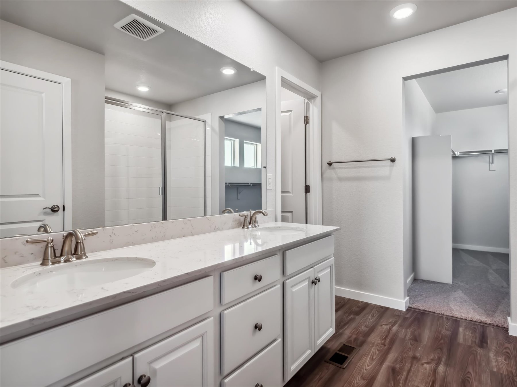 A bathroom with a large mirror.