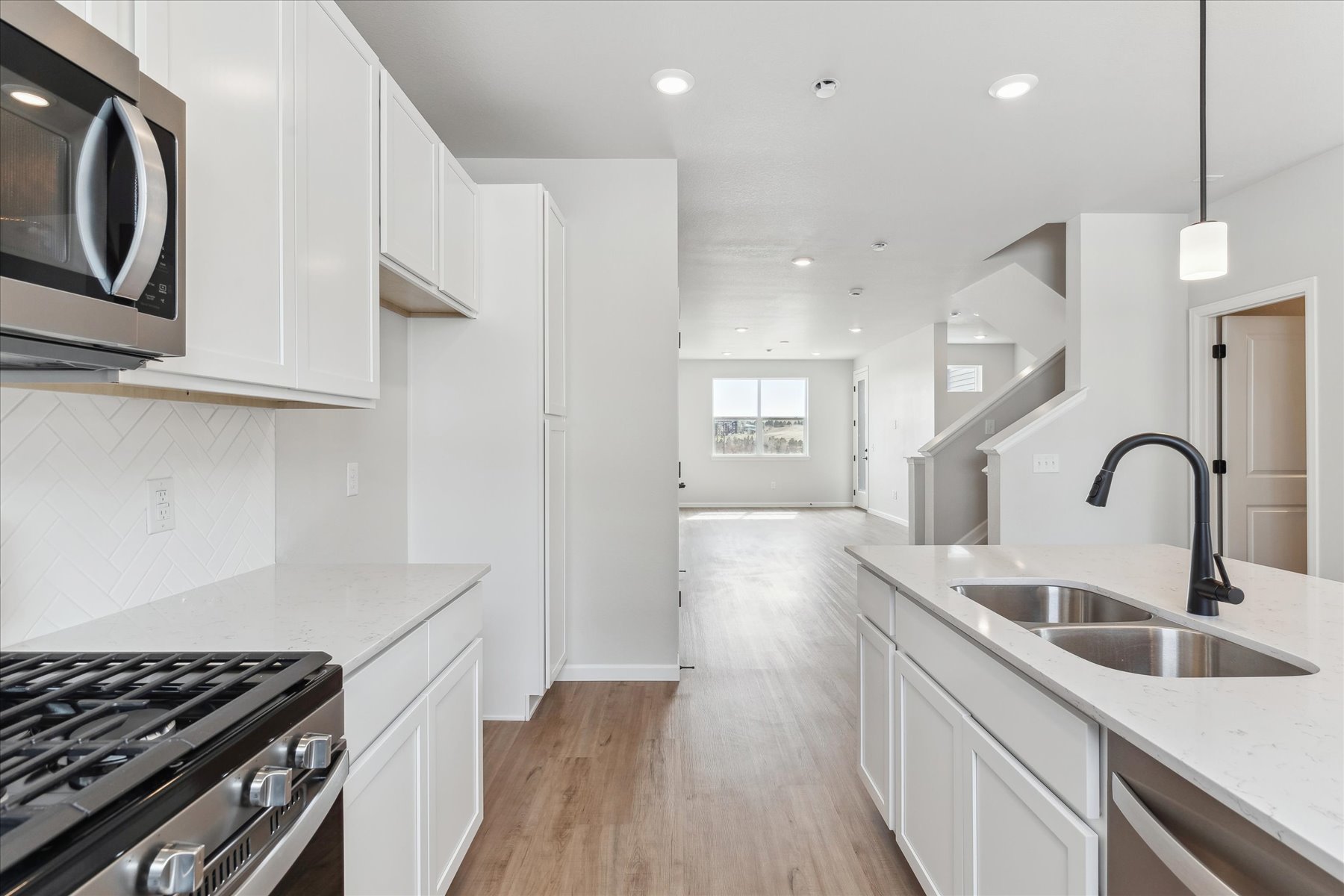 A kitchen with white cabinets.