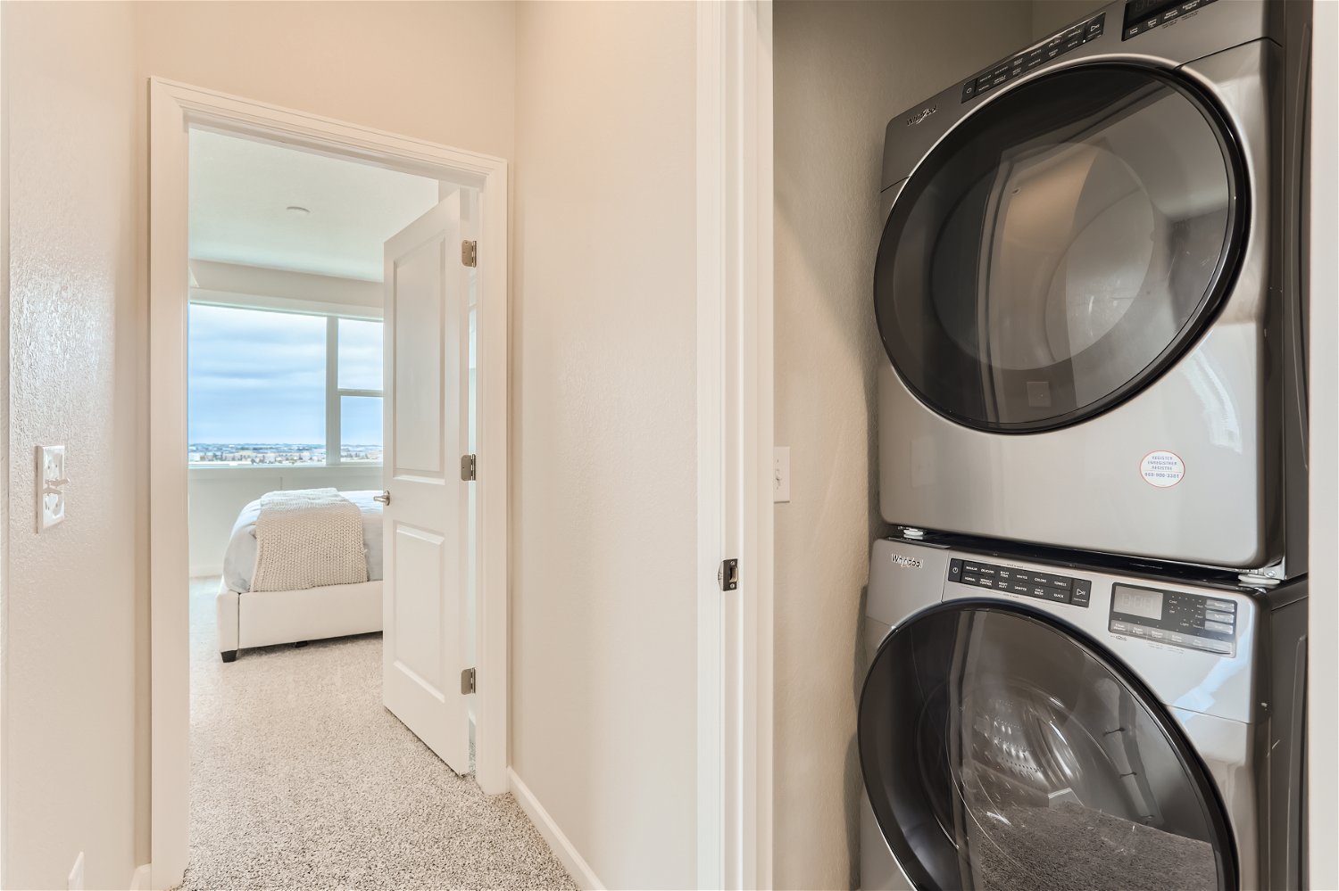 A room with a washing machine and a window.