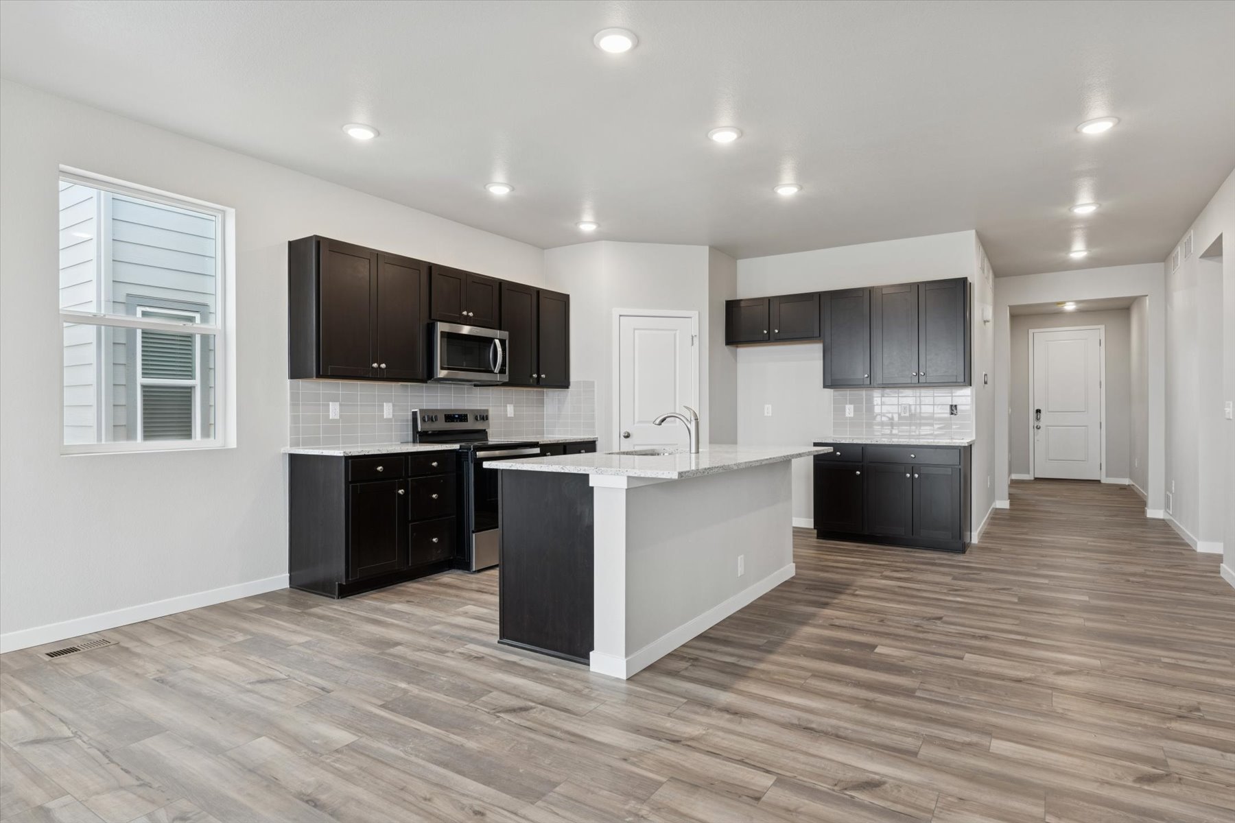 A kitchen with black cabinets.