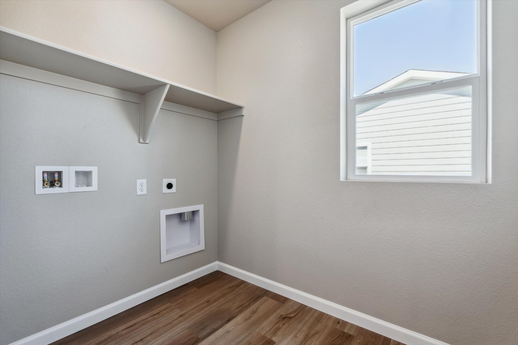 A room with white walls and a wood floor.