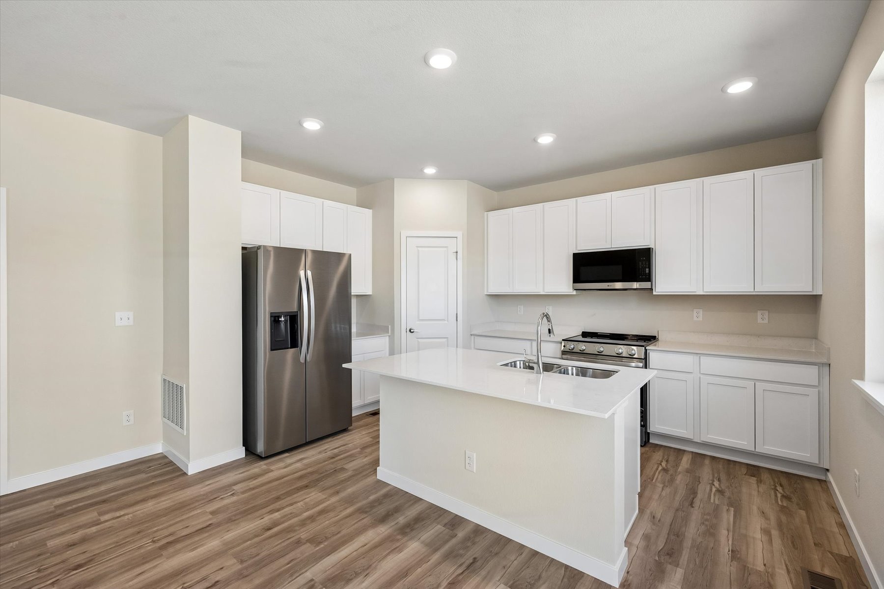 A kitchen with white cabinets.