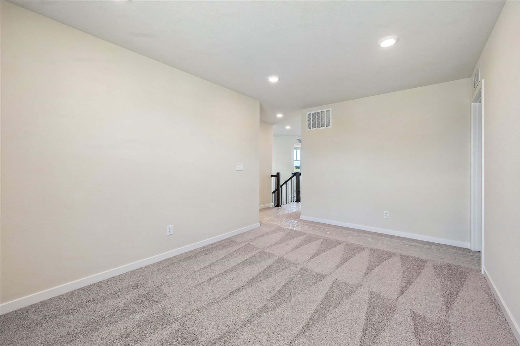 A hallway with a carpet.