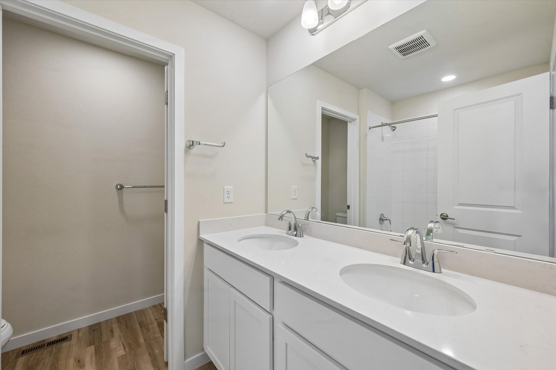 A bathroom with a large mirror.