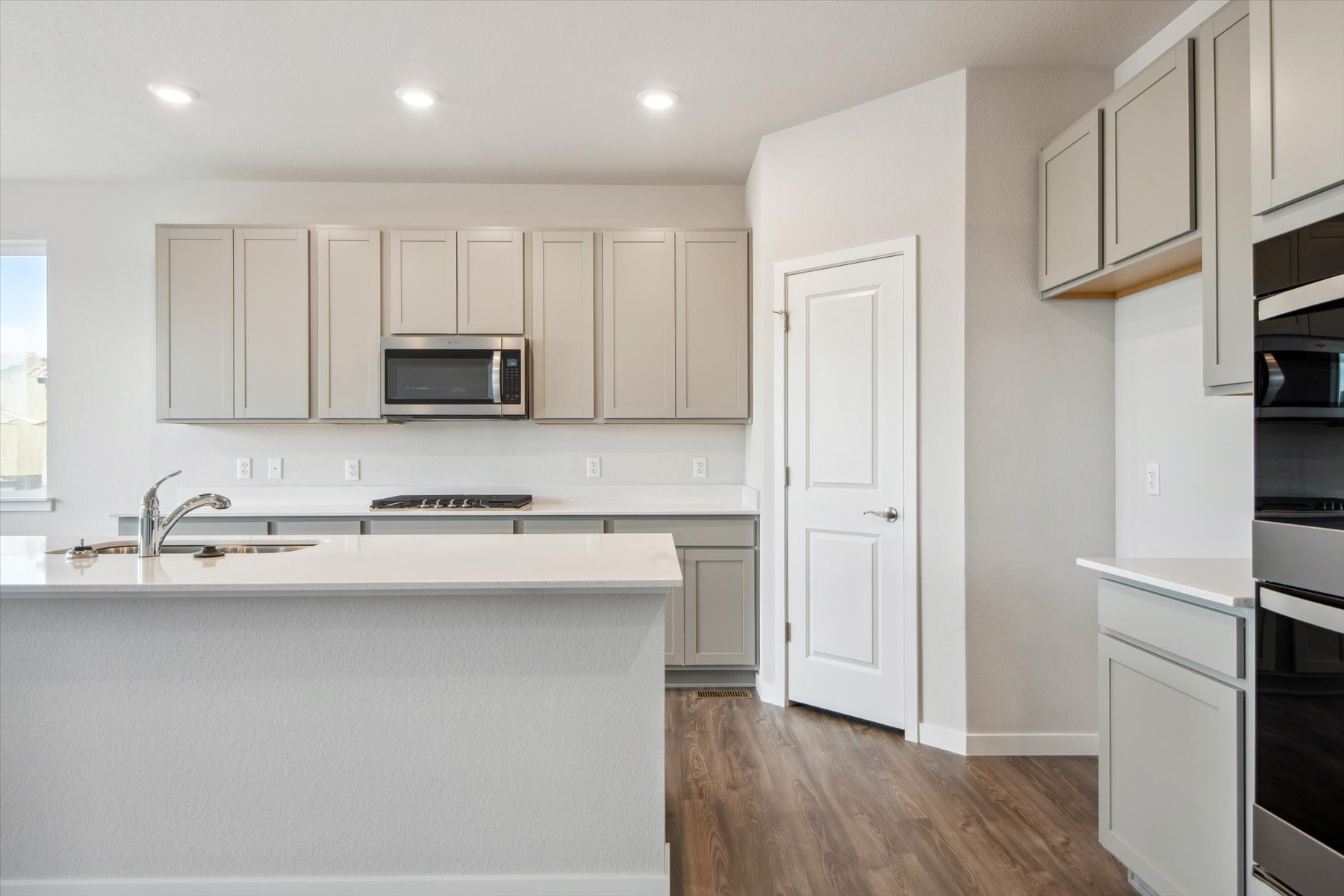 A kitchen with white cabinets.