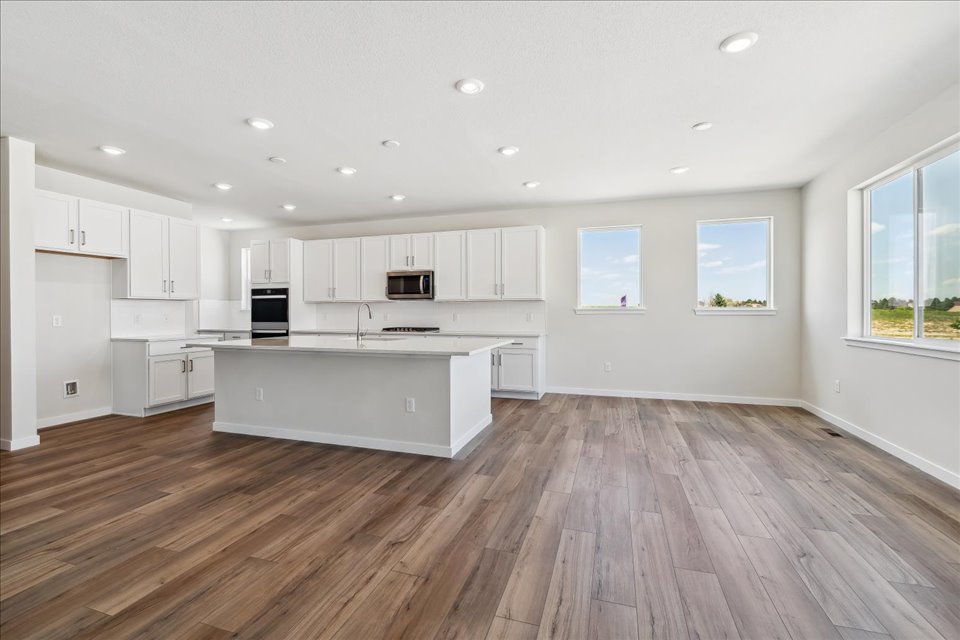 A large kitchen with white cabinets.