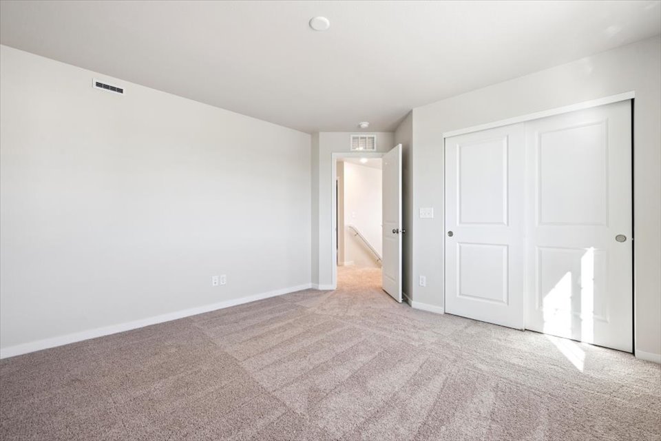 A hallway with white doors.