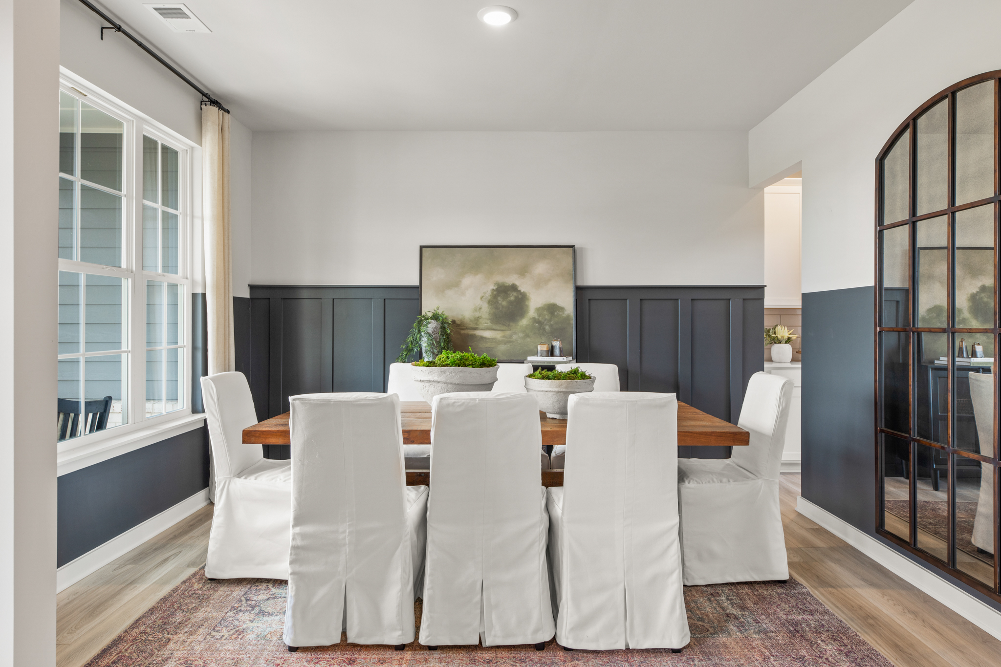 A dining room with a large table.