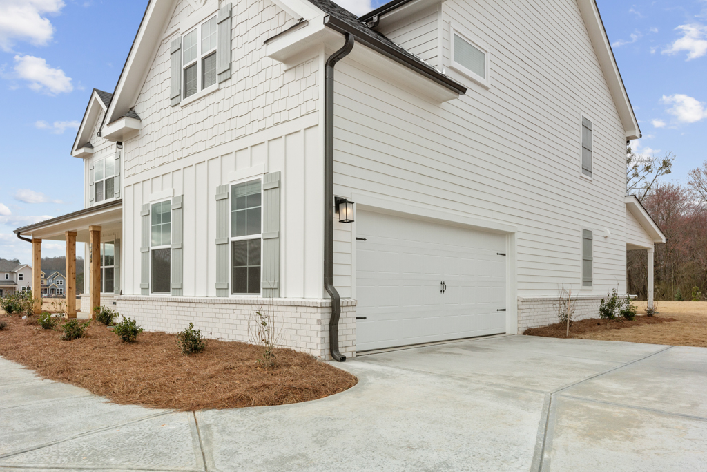 A white house with a garage.