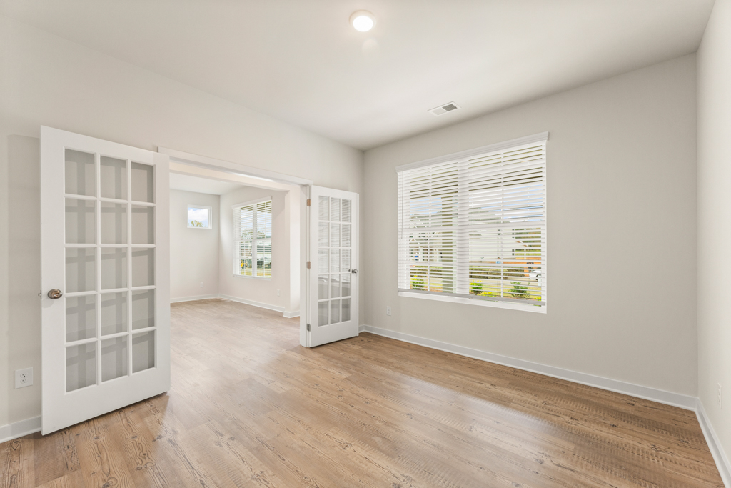 A room with white walls and a wood floor.
