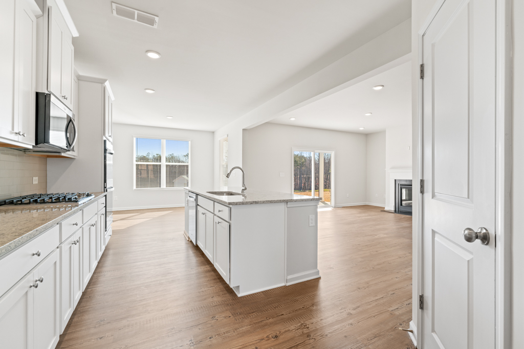 A kitchen with white cabinets.
