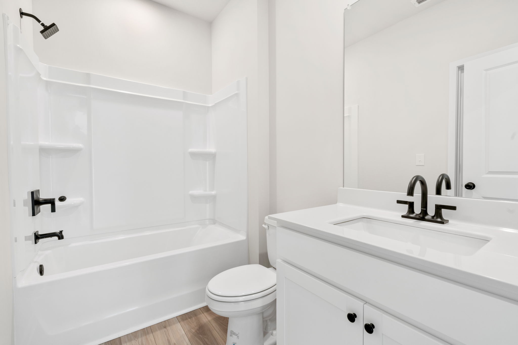 A bathroom with a tub sink and toilet.