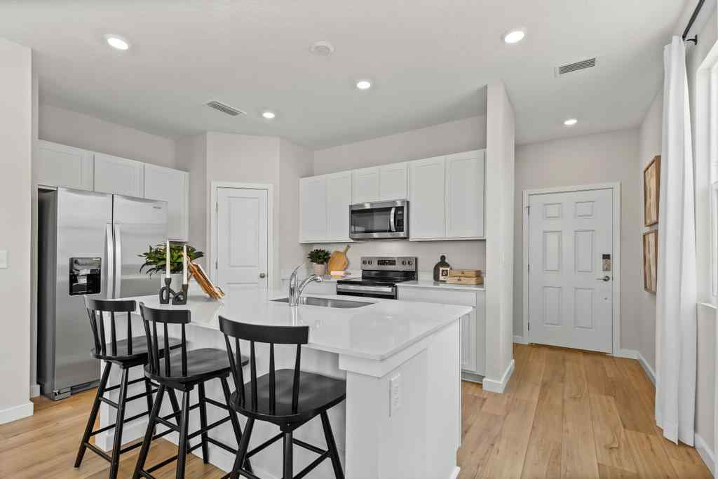 A kitchen with white cabinets.