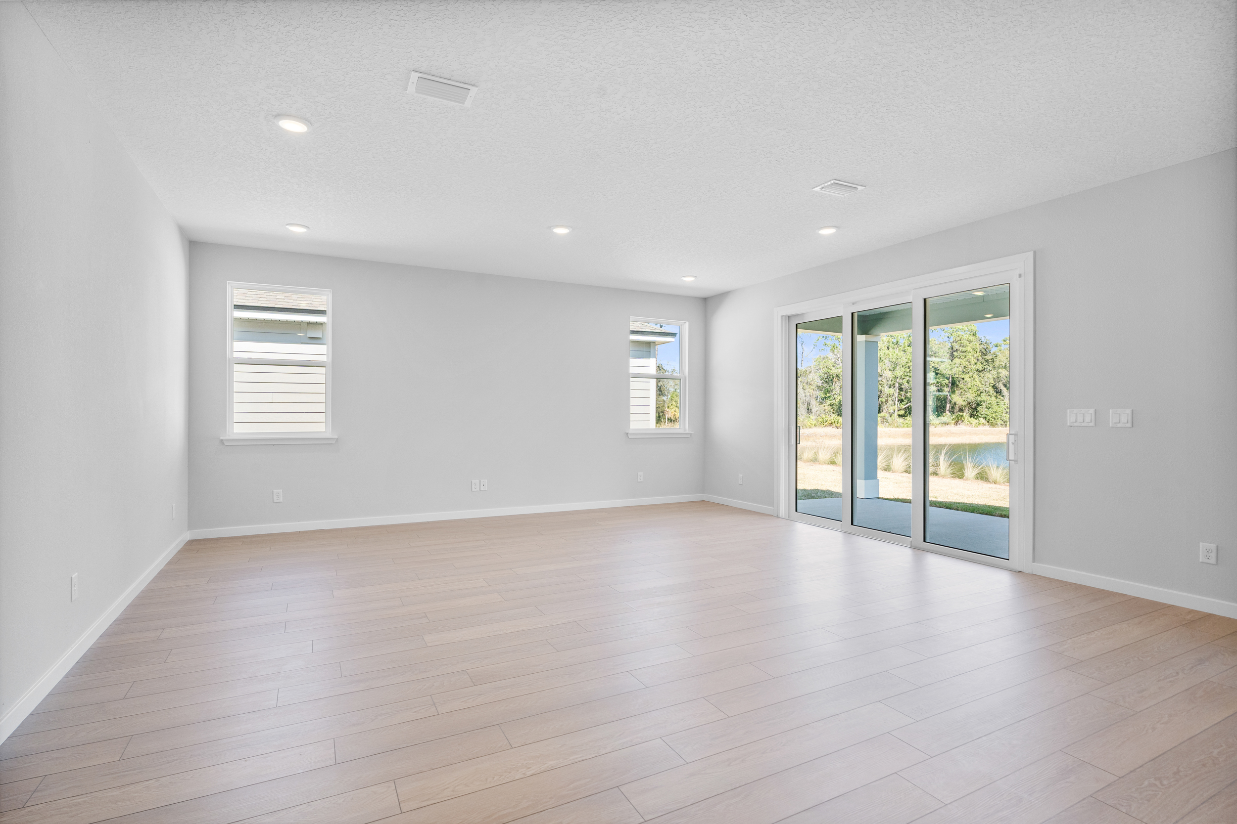 Lot 139 Living Area with Large Sliding Doors to Covered Patio at Reserve East