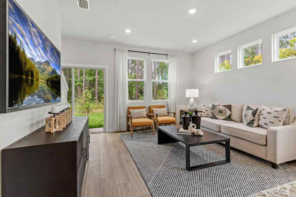 A living room with a large painting.