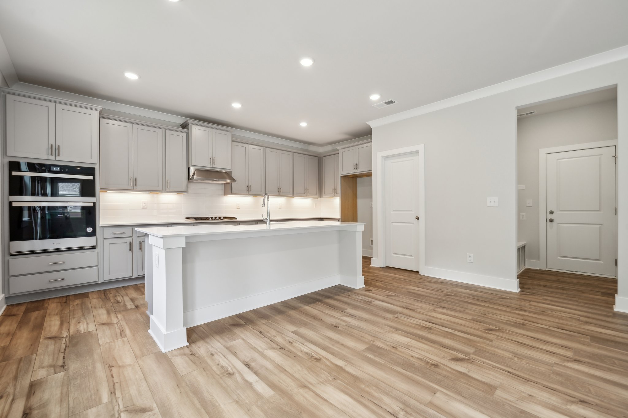 A kitchen with white cabinets.