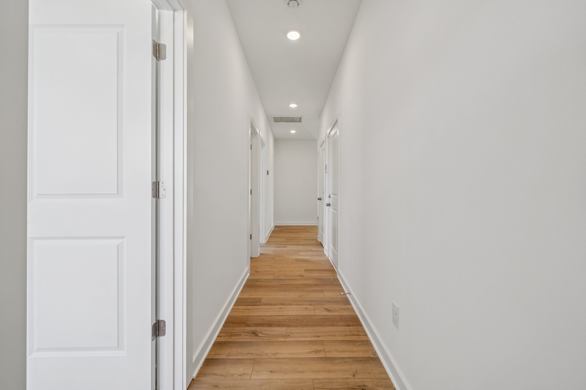 A hallway with white doors.