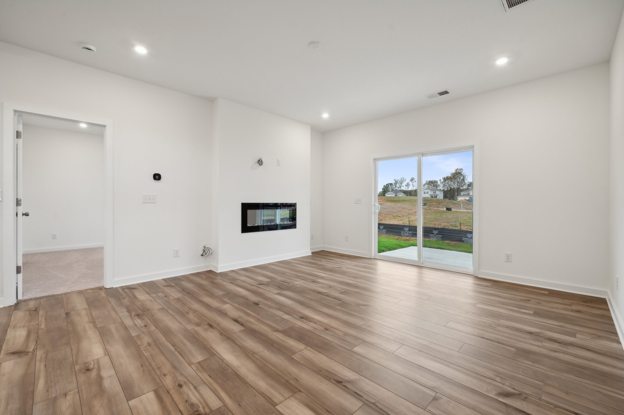 A room with a wood floor and a wood floor with a window.